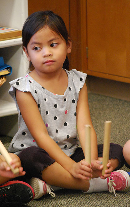 Beating rhythms with sticks at music time
